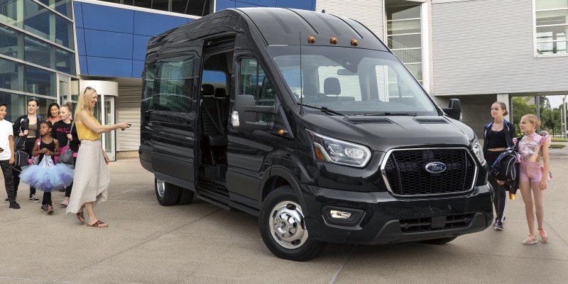 2025 Ford Transit van in black, with its doors open, welcoming passengers in Stephenville, TX