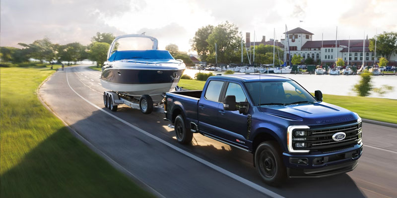 2026 Ford F-350SD towing a boat on a scenic roadway