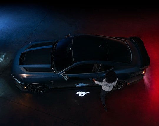 2024 Ford Mustang® Dark Horse™ model with a driver approaching the vehicle | Triple Crown Ford in Stephenville TX