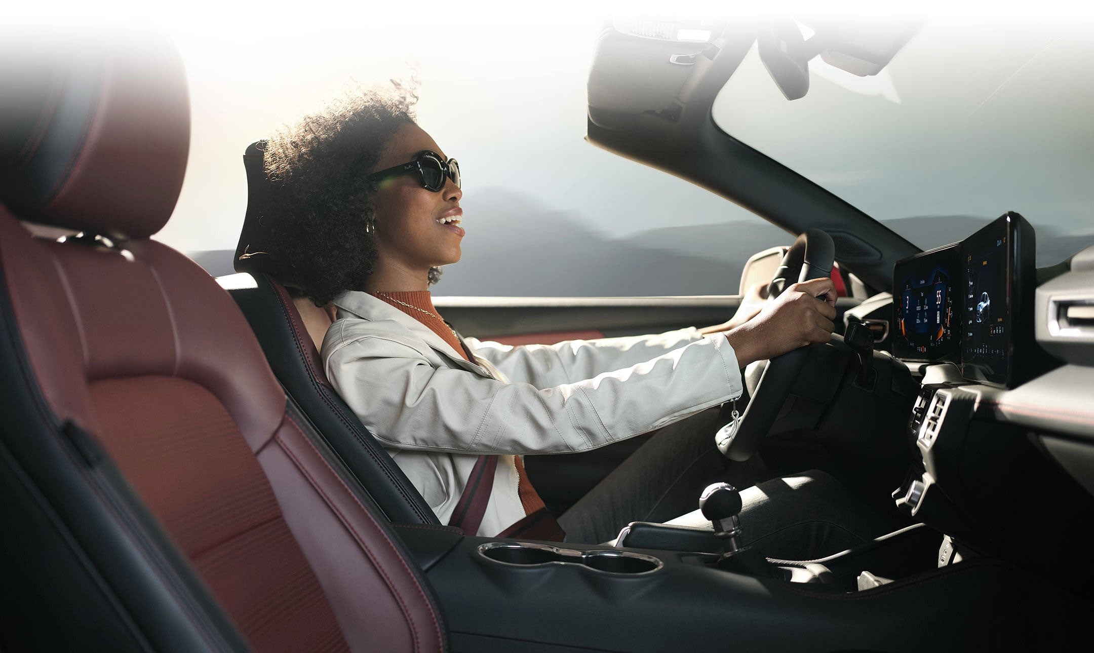 Person sitting in the driver’s seat of a 2024 Ford Mustang® convertible | Triple Crown Ford in Stephenville TX